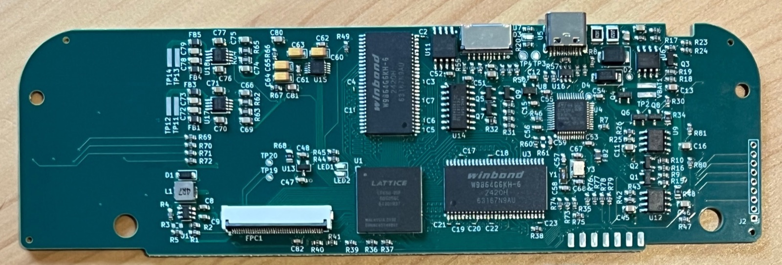 A custom PCB: an FPGA, two SDRAM chips, a USB‑C connector and dozens of small passive components